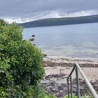 Make your way down the concrete steps that lead to the beach. You’ll find them on the left hand side as you face the loch.