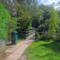 Turn right when facing the library and walk down this path, crossing over the bridge