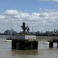 A Damien Hurst artwork on the riverside.