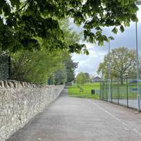 Continue on the wide path with tennis courts to the right. You're heading slightly uphill to enter Paulton Memorial Park.