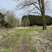 Bear diagonally left across the small green space on an obvious trodden grass path.