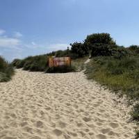 Follow the boardwalk to the end and onto the sand. Turn right to walk slightly uphill. Dogs should be on leads here from May - September.