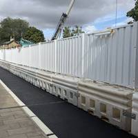 Head under the bridge alongside the construction site. If this clears up you should be able to stay on the right side pavement instead.