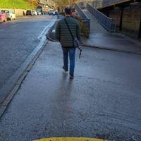 Cross the station car park access road and continue along the pavement.