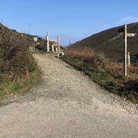 At the bottom of the road there is a hairpin bend. Turn immediately left and join the South West coast path.