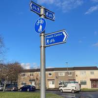 There’s a cycle and footpath sign outside the health centre. Turn right to follow it along Alison Lea.