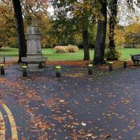 Bear left with the road and just pass the fountain, take the hard but knobbly path parallel to the road.