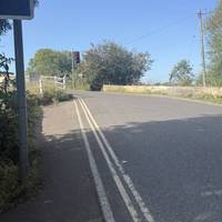 The bridge is a single track controlled by traffic lights and with no pavement. For a short detour to the older bridge cross over the river.