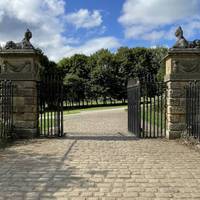 Pass through another set of stone gateposts on the flat cobbled path.
