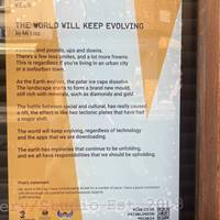 Spot the poem “The World Will Keep Evolving” by Mr Lisp in the window of The Muse.