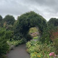 Walk down the path and see the entrance to the Rose Garden.