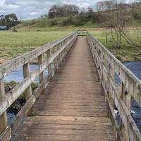 Use the wooden bridge to cross Avon Water.