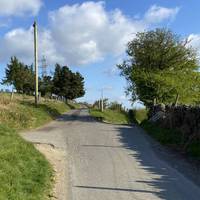 At the fork in the road take the road on the left to continue your route towards the common.