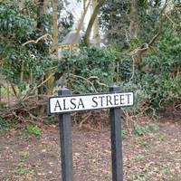 You’ll reach a sign for Alsa Street. Continue along the road.