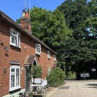 Just up ahead to the left, you’ll see a small row of two cottages.