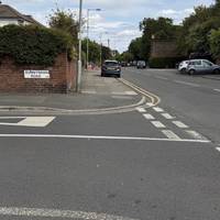 Use the dropped kerb to cross over Sunny Bank Road.