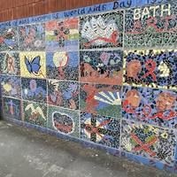 Cross Morley Street and pause to admire the World Aids Day mosaic on the other side. Then turn left.