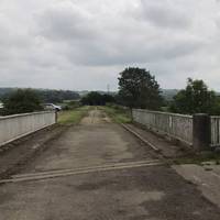 At the top of the stairs, turn right and walk over the bridge.