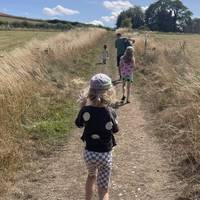 Go through the gate on the other side and head up the hill between the fields.