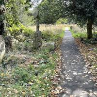 Now take the second turning on the right. Walk ahead past one circle of graves where there is a cross path.