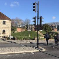 Exit to the road and carefully cross over at the lights. Then turn left.