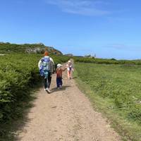 Follow the smaller path to the main path and head right towards the buildings at the centre of the island