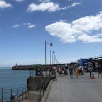As you reach the end of the station, take a right onto the walkway along the shingle beach. You can grab beverages from the Harbour Arm