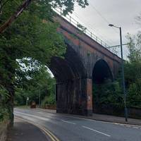Upon exiting, you’ll have a view of the viaduct above Mottram Road. Walk along the road towards the viaduct.