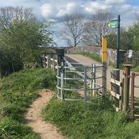 Pass through the metal gate. Then cross over the bridge and take the footpath on your right.