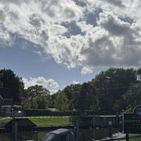 Walk past the lock with lock keepers house. The weir is on the other side, behind the house. There are toilets here, last loos for a while.