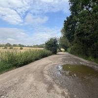 Find the gravel car park area (next to the river side picnic area).