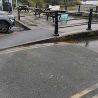 Cross the road that gives access to the lake itself via dropped kerbs. Turn right past the picnic tables near the accessible parking bays.