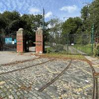 Head through the gates to enter Heaton Park which we're exploring on our walk today. Notice the tram tracks here.