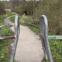 Carry on through the barriers to continue along the path.