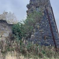 Walk round the fencing protecting the mill remains and past the polytunnels and tool cabins.