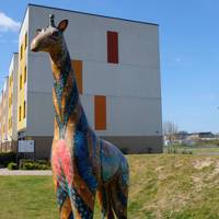 There will be a multi coloured mosaic giraffe 🦒 as you walk towards the zig-zag railway bridge.