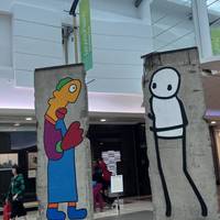 Just beyond Starbucks and opposite the sports shops you’ll find fragments of the Berlin Wall adorned with artwork by Thierry Noir & Stik.