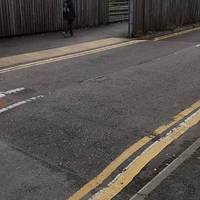 Just before the end of the road, cross to the left via tactile paving and turn right on the tarmac path.