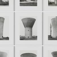 Named after ‘Water Towers’ by Bernd and Hilla Becher, anonymous sculptures stand silently amidst the cityscape etching the passage of time.