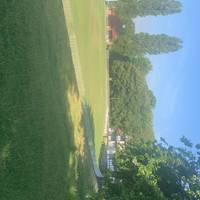 Before long you will see an opening to trees on your right- a cricket game may on. Take a look at the pitch and clubhouse