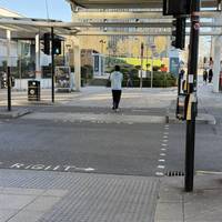 Cross International Way road at the lights.