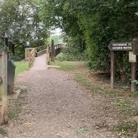 The sign points to Shallows Bridge as the route to Haysden Water. Opposite is a notice board with information about the park