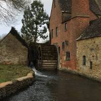 Follow the stream to the Old Mill and water wheel. Go round the mill and past the cafe and shop about 15 meters. The footpath is on the left