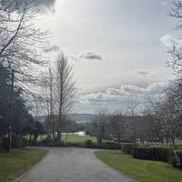 Continue straight down the tarmac path with this spectacular over the park. Get ready to take the path to the right.