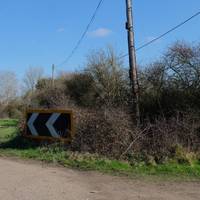 The road will then turn to the left. If you look to your right you’ll notice a footpath sign.