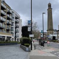 Bear left to take the pedestrian path, continuing forward.