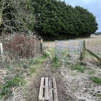 Exit the greenspace by a metal kissing gate.