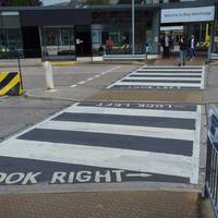 Pass through Bury Interchange, served by buses from many locations, via four zebra crossings with tactile paving.