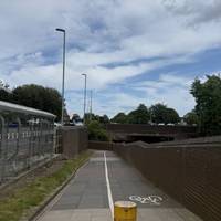 Outside the station, turn right and walk down the shared-use ramp.