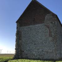 It was made from part of a Roman fort from circa AD 250. The fort itself has been lost to erosion, what is left is protected below a meadow.